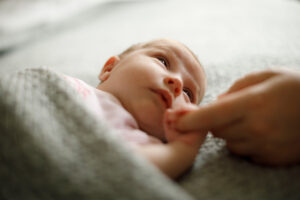 photo of a baby holding onto a finger