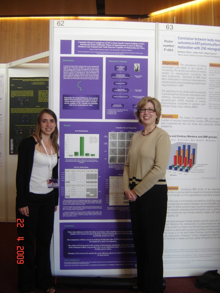 Marina Peluffo and Teresa Woodruff stand in front of the abstract poster Peluffo won an award for at the 15th World Congress on IVF in Geneva, Switzerland in April 2009.